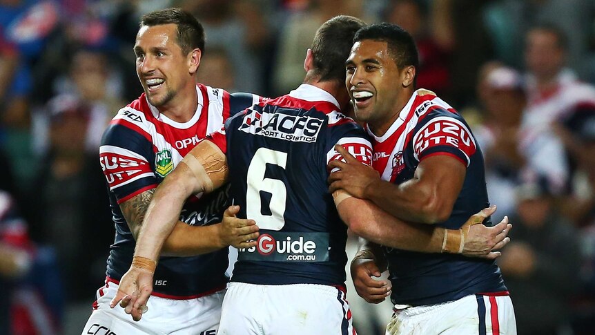 Try time ... Michael Jennings (R) celebrates with Mitchell Pearce (L) and James Maloney