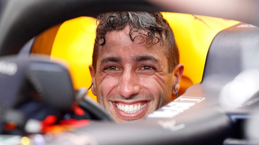 Daniel Ricciardo smiles from the cockpit of his car.