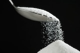 Sugar pouring from a spoon