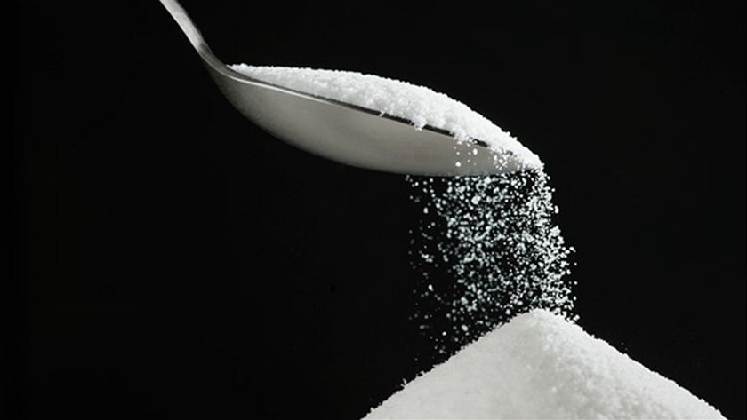 Sugar pouring from a spoon