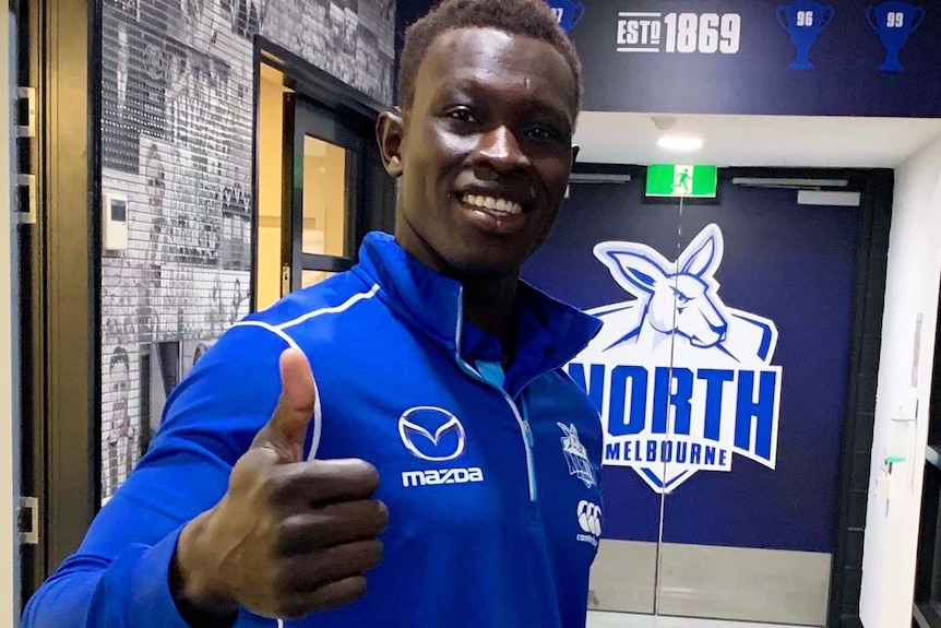 Majak Daw gives the thumbs up and smiles at the camera.