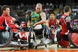 Australia's Ryley Batt (C) and Canada's Zak Madell (L) in 2000 Paralympics Wheelchair Rugby final.