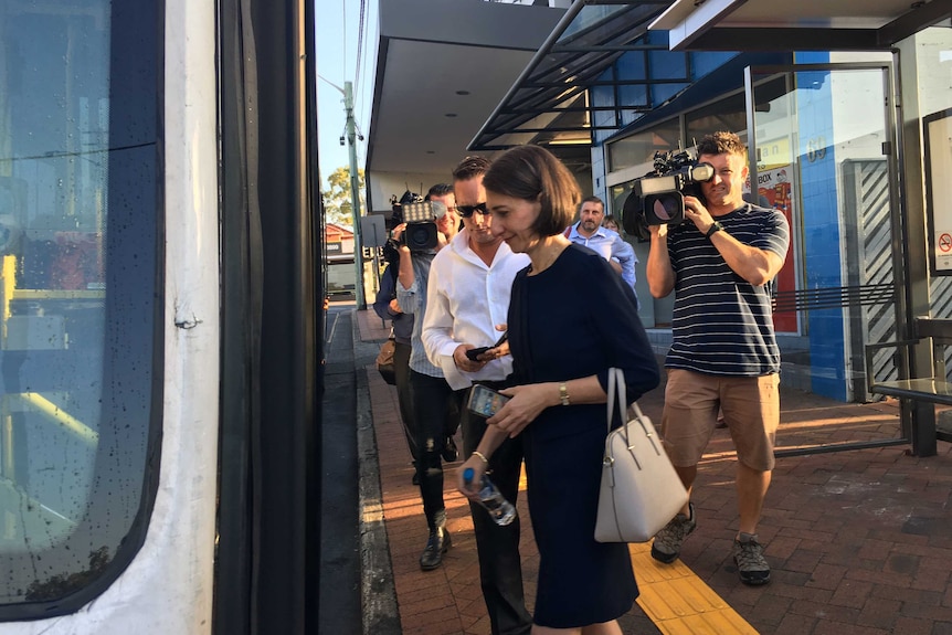 Gladys Berejiklian boards a bus.