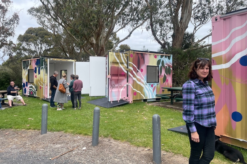 people talking around the art cubes