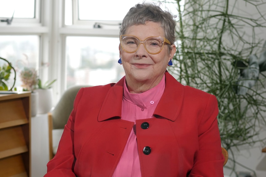 Professor Roberta Ryan sitting in her home, smiling at the camera
