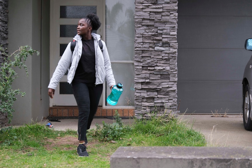 Teenage girl leaves home in puffer jacket and backpack