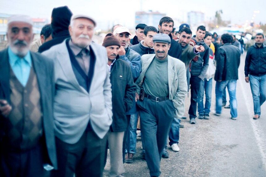 Turkish quake survivors queue for aid