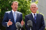 Dan Tehan and Malcolm Turnbull speak at a press conference.