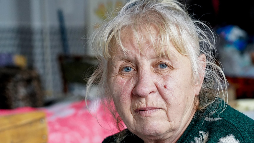 A tight portrait of a blonde woman with blue eyes 