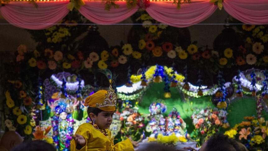 A young boy is dressed as baby Krishna at the Hare Krishna temple.