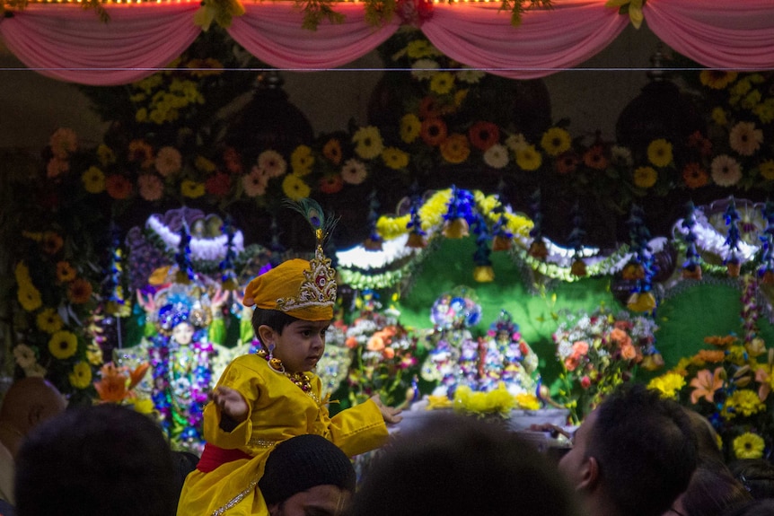 A young boy is dressed as baby Krishna at the Hare Krishna temple.