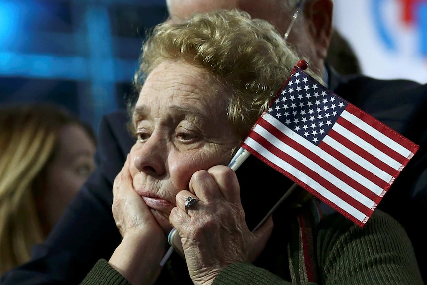 A supporter of Democratic presidential nominee Hillary Clinton watches and waits at her election night rally