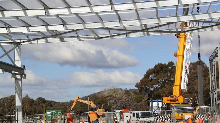 Steel frame on construction site, with man in high-vis