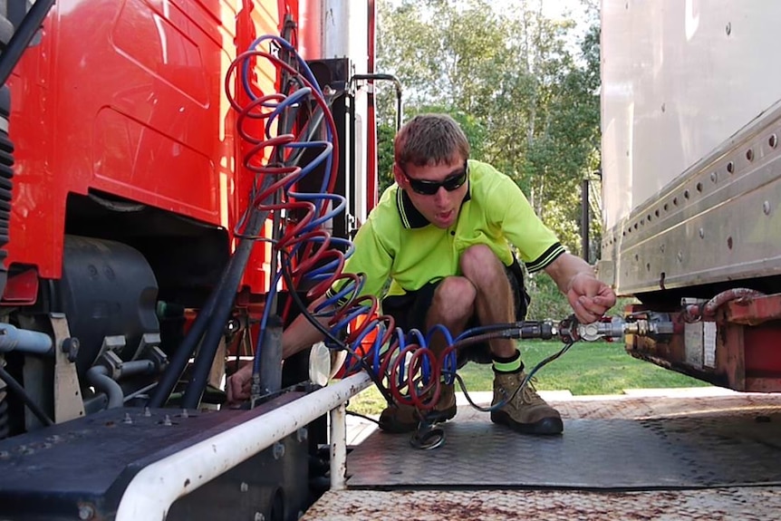 A man standing in front of a truck