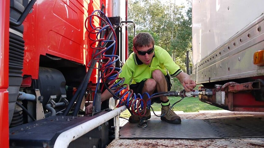 A man standing in front of a truck