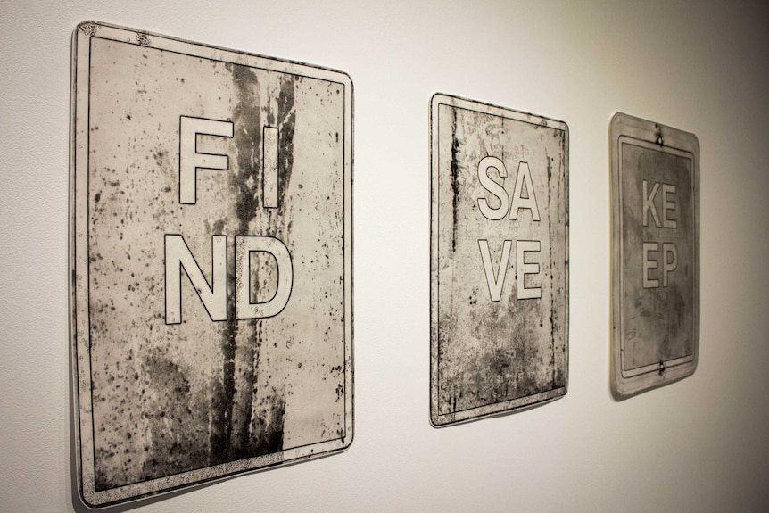 Three signs reading 'find' 'save' and 'keep' in Jenny Peterson's exhibition.