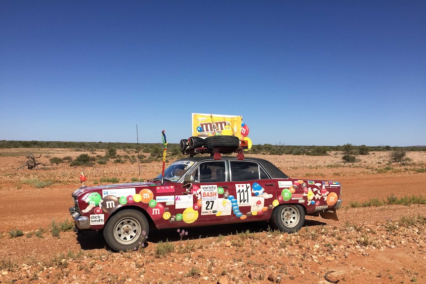 Brian Muller's car in the Australian outback surrounded by barren landscape.
