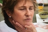 Photo of woman with brown hair and her eyes closed