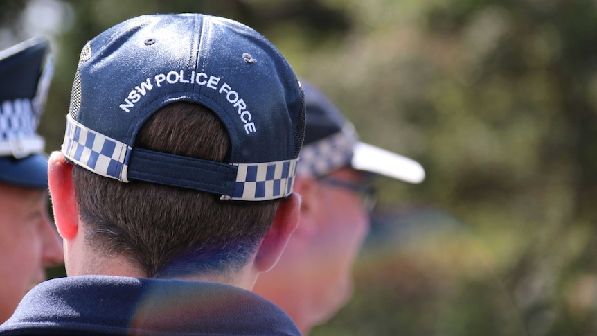 the back of a NSW Police officer's head showing his police cap
