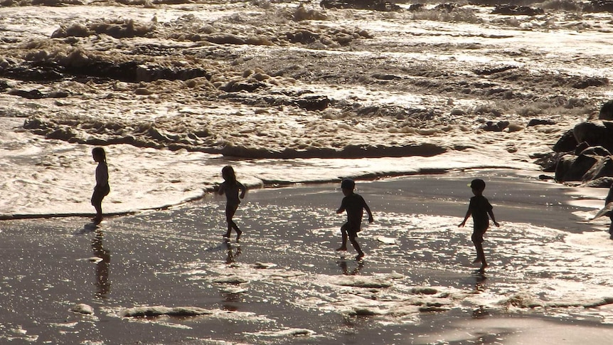 Children play at the beach