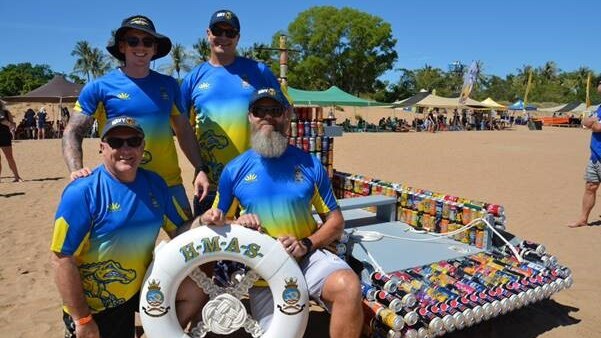 Regatta winning crew Junior Balk stand next to their creation.