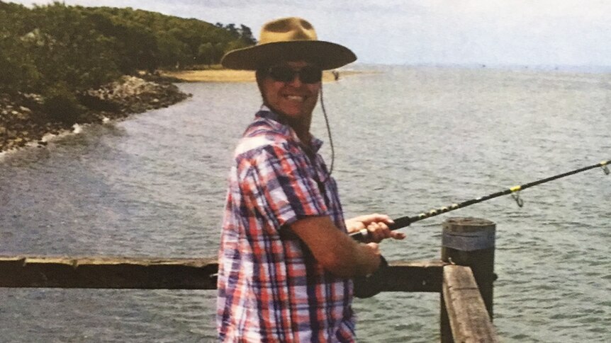 Quentin Smith smiling as he fishes at an unknown location