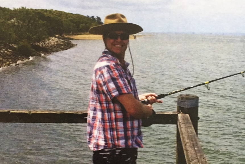 Quentin Smith smiling as he fishes at an unknown location