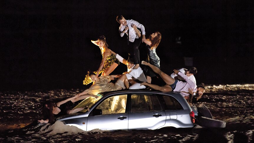 Stylistic image of a group of people in tableau atop a sinking car