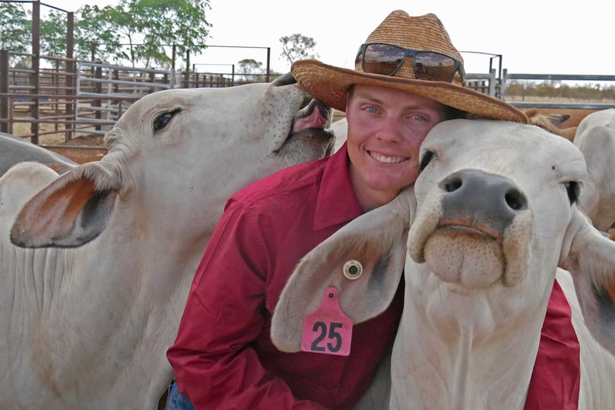 a man hugging a cow.