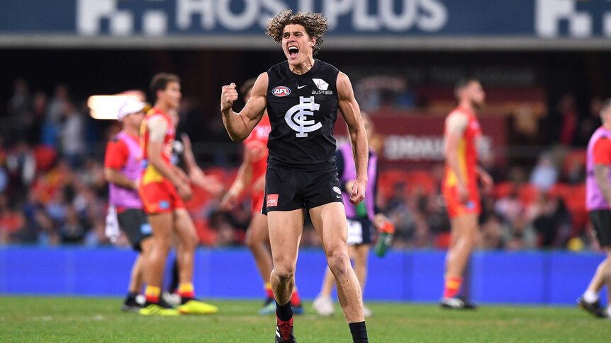 Charlie Curnow pumps his fist after scoring against the Suns
