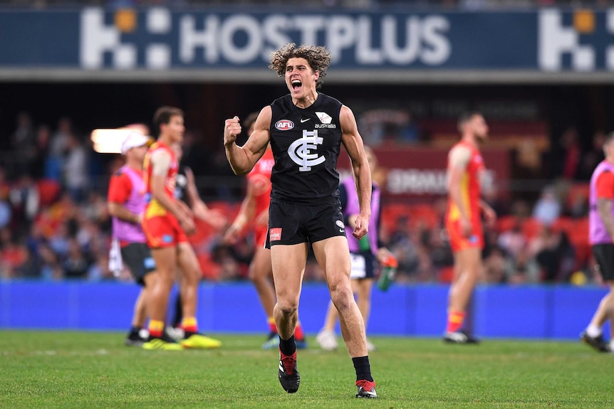 Charlie Curnow pumps his fist after scoring against the Suns