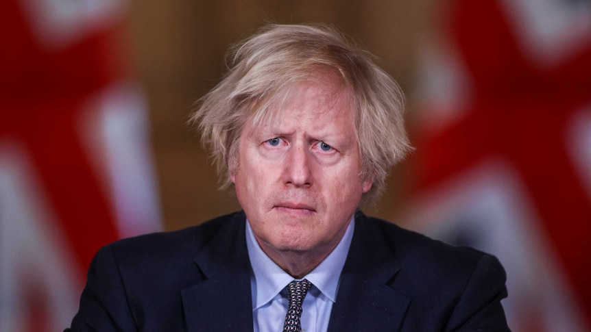 British Prime Minister Boris Johnson wears a dark suit