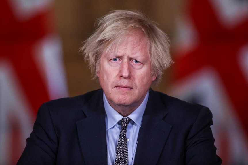 British Prime Minister Boris Johnson wears a dark suit