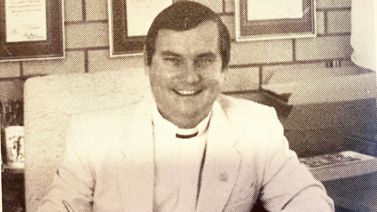 A man in religious clothing in a black-and-white photograph.