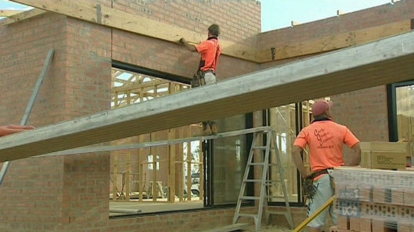 Workers on a house construction site