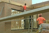 Workers on a house construction site