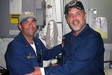 Maersk-Alabama Captain Richard Phillips, right, stands alongside Cmdr Frank Castellano