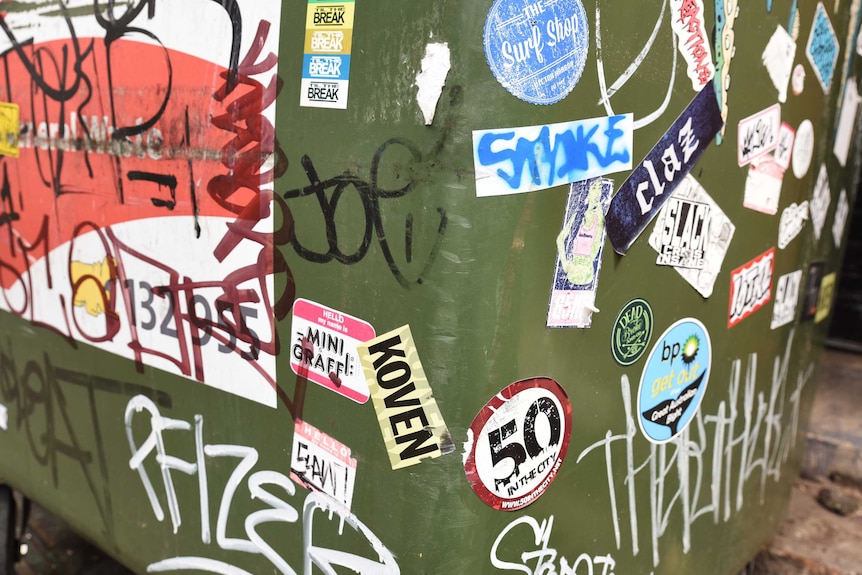 Koven's sticker on alleyway bin