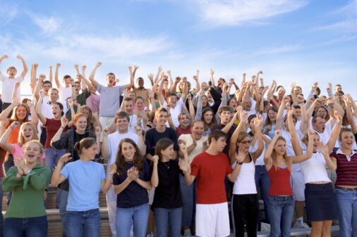 Crowd of youth cheering (Thinkstock: Comstock)