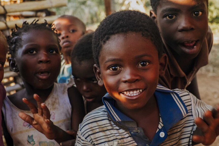 A small group of young children looking happy in a slum in Mozambique