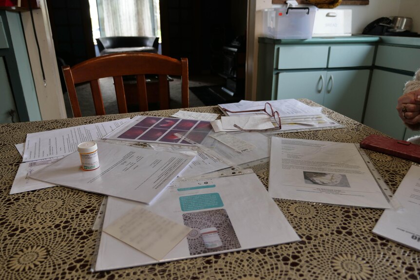 A table covered in printed documents.