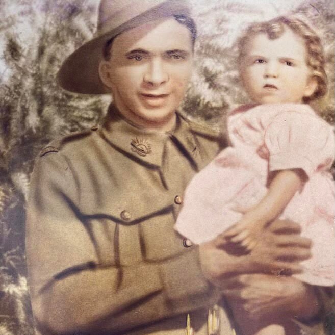 An artwork of Jimmy in army uniform holding his baby sister in his arms who is wearing a pink dress