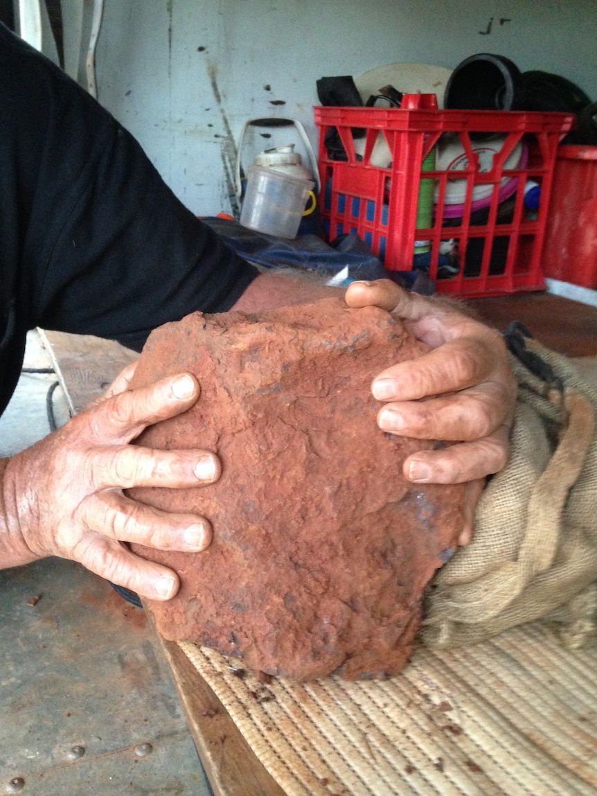 The rock is covered in red dirt.