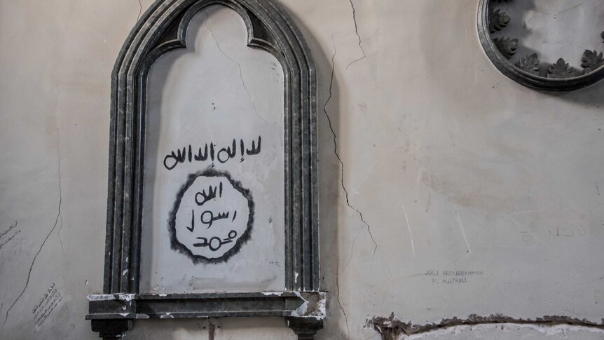 IS fighters have graffitied a church in Arabic and English scripture denoting the man is Australian.