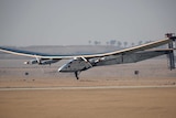 The Solar Impulse 2 comes in to land at the sandy Cairo Airport.