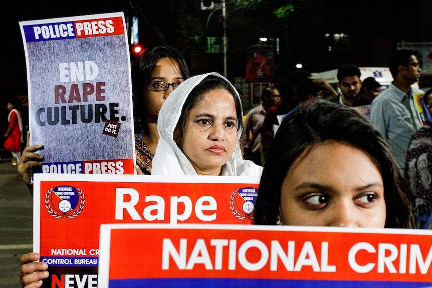 Indians protest against rape holing up posters.