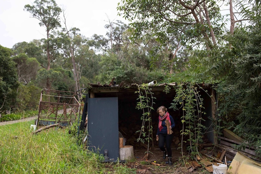 Sarah Smethurst collects wood from a shed.