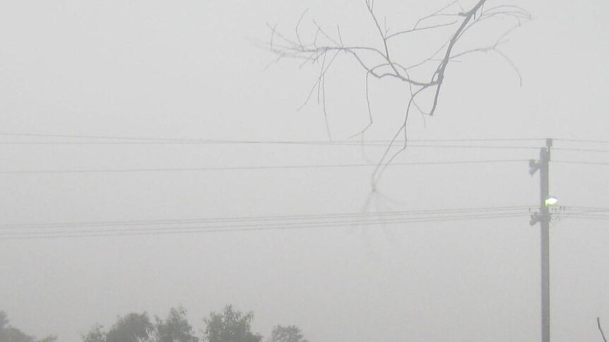 Misty, dark skies and rain above deserted street in coastal town of Onslow