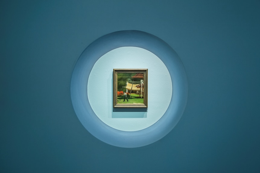 A Clarice Beckett painting in the centre of a circle in an exhibition