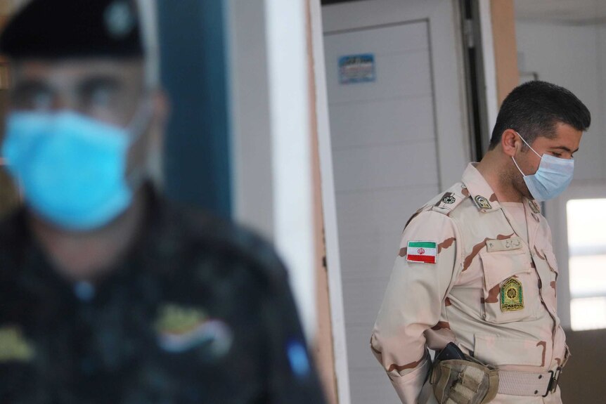 A member of Iranian Border Guards wears a protective face mask.